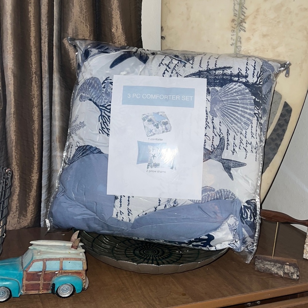 King size comforter with 2 pillow shams.  White, navy and blue beach themed.